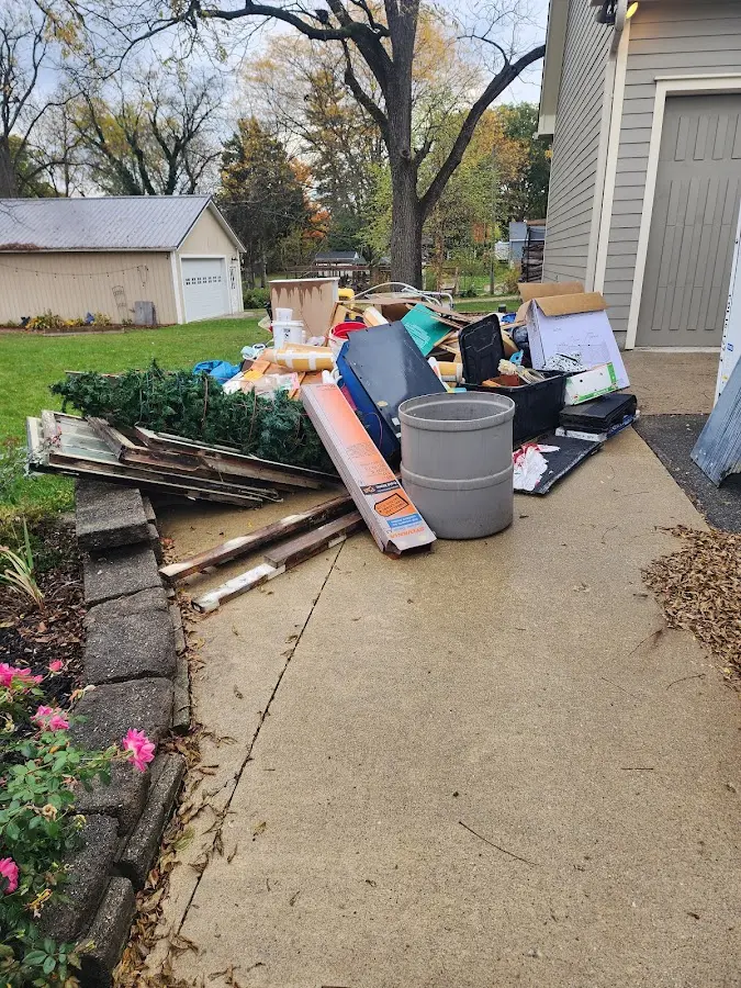Dumpster being loaded with debris for Residential Dumpster Rental in Clinton